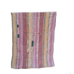 A striped textile blanket or throw with pink, yellow, and orange vertical patterns draped over a black metal stand against a white background