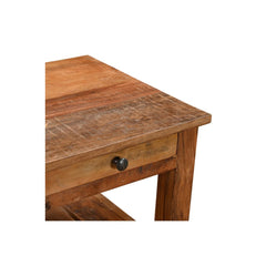 Close-up of a rustic wooden table corner showing a drawer with a round black knob, a thick wood top, and a leg on a plain white background.