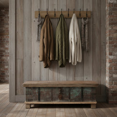 rustic wooden trunk in a hallway with coats hanging above
