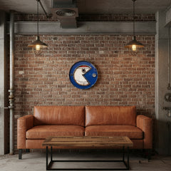 Round metal oil dipstick pacman with blue rim on a brick wall in an industrial style living room