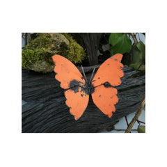 metal butterfly orange on a wood setting