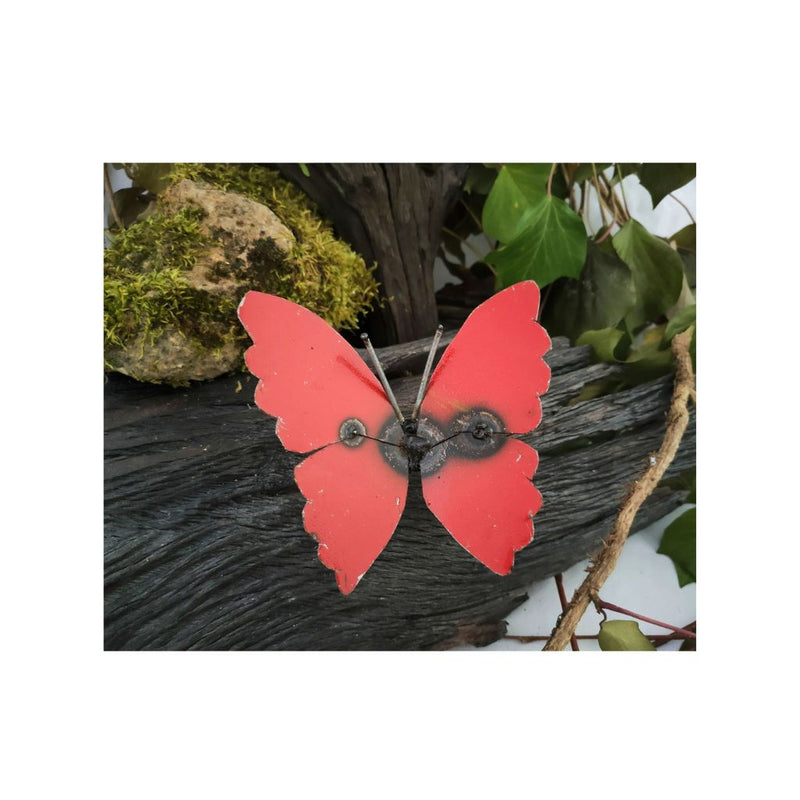 Red butterfly decorative item on a natural background