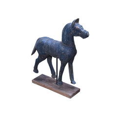 Wooden horse sculpture on a stand with a white background