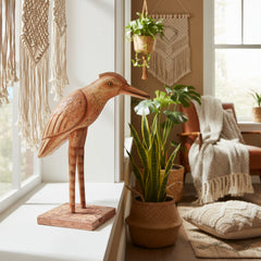 Orange wooden bird on a window sill