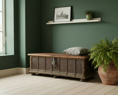 Bharata Wooden Trunk Dark Brown Shekhawati 7 Panel Door With Light Lid Option 7 Front in an entrance against a dark green wall