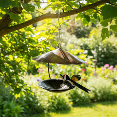 Recycled Metal Bird Feeder with Goldfinch hanging from a tree