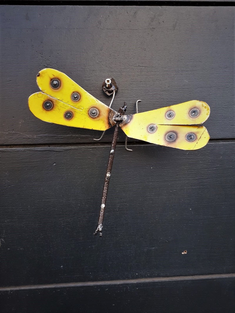 Yellow Metal Dragonfly Front View Hung on a Wall Outside