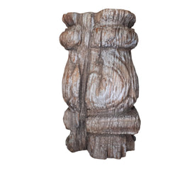 Reclaimed carved wood pillar or leg with metal candle holder cup. The wood is old, a bit cracked with a past grey paint.