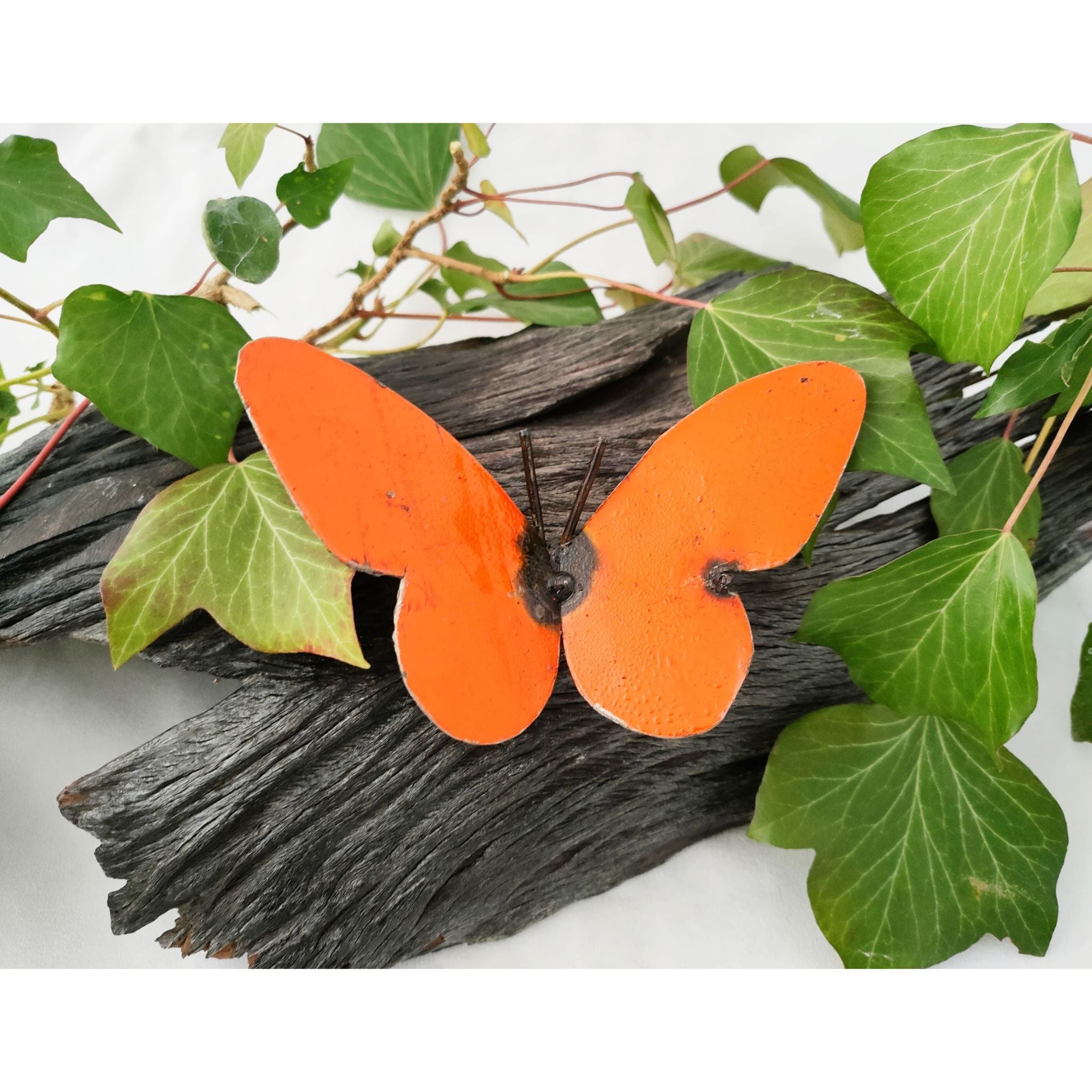 Medium Recycled Metal Art Butterfly orange colour one on log