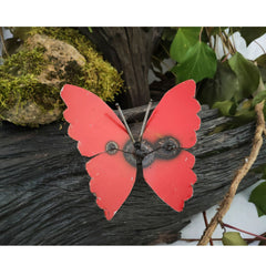 Small Recycled Metal Butterfly red colour front view on log