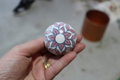 handpainted and made ceramic knob with pink flowers in hand 