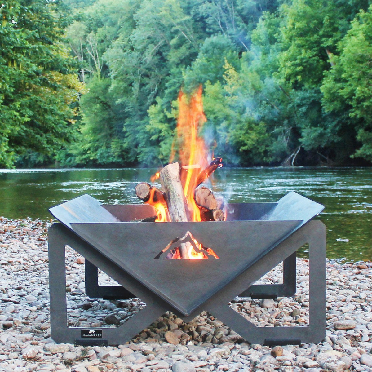 Fire Pit Brasero with logs stacked in pit. 